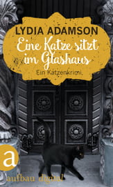 Eine Katze sitzt im Glashaus