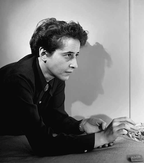 Schwarz-weiss-Fotografie von Fred Stein. Abgebildet wird eine Frau mit Zigarette in der Hand, die sich mit dem Ellboten auf einer weichen Oberfläche abstützt.